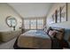 Bright bedroom with natural light, neutral decor, and a side table for bedside use at 7679 S Biloxi Way, Aurora, CO 80016