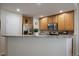 Bright kitchen featuring granite countertops, stainless steel appliances, and ample cabinet space for storage at 7679 S Biloxi Way, Aurora, CO 80016