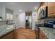 Modern kitchen with stainless steel appliances, granite countertops, and wood flooring for a clean look at 7679 S Biloxi Way, Aurora, CO 80016