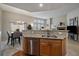 Spacious kitchen featuring wood cabinets, granite countertops, stainless appliances and a dining area at 7679 S Biloxi Way, Aurora, CO 80016