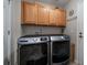 Well-equipped laundry room with modern washer and dryer and ample cabinet space at 7679 S Biloxi Way, Aurora, CO 80016