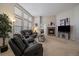 Sunlit living room showcasing a fireplace, plush seating, and access to other living spaces at 7679 S Biloxi Way, Aurora, CO 80016