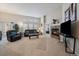 Inviting living room with comfortable seating, a warm fireplace, and sliding door access to the backyard at 7679 S Biloxi Way, Aurora, CO 80016