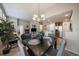 Open-concept living room featuring a dining area, kitchen, and cozy seating by the fireplace at 7679 S Biloxi Way, Aurora, CO 80016