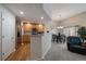 Inviting kitchen and dining area featuring stainless steel appliances, wood floors, and an adjacent living area at 7679 S Biloxi Way, Aurora, CO 80016