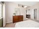 Inviting bedroom with a view into the ensuite bath featuring a skylight and wooden cabinets, offering a serene and private retreat at 9271 Wheeler Ct, Highlands Ranch, CO 80126