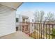 Balcony with railings that offer a view of a white blossomed tree at 1383 W 88Th Ave # 307, Thornton, CO 80260