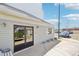 Building entrance features double glass doors, flower beds, and a window, located near the parking area at 1383 W 88Th Ave # 307, Thornton, CO 80260
