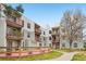 View of a multi-story apartment building with outdoor seating and beautiful landscaping at 1383 W 88Th Ave # 307, Thornton, CO 80260