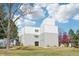 Exterior of the building with green lawn and mature trees enhancing the natural beauty and curb appeal of the property at 1383 W 88Th Ave # 307, Thornton, CO 80260