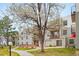 Exterior of a multi-story apartment building with balconies and blooming trees at 1383 W 88Th Ave # 307, Thornton, CO 80260