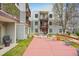 Condo complex shows a patio area with an umbrella, tables and chairs at 1383 W 88Th Ave # 307, Thornton, CO 80260