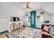 Finished attic space with hardwood floors, a patterned rug, and lots of natural light at 3106 N Franklin St, Denver, CO 80205