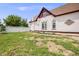 Spacious backyard with a white fence, a quaint house, and a patch of greenery at 3106 N Franklin St, Denver, CO 80205