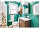 Stylish bathroom with green walls, a classic vanity, and updated fixtures at 3106 N Franklin St, Denver, CO 80205