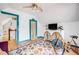 Bright bedroom featuring a colorful rug, modern ceiling fan, and turquoise trim accents at 3106 N Franklin St, Denver, CO 80205