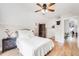 Bright bedroom with hardwood floors, white linens, a unique room divider, and a ceiling fan at 3106 N Franklin St, Denver, CO 80205