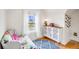Bright bedroom features stylish furniture, natural light from window and white walls at 3106 N Franklin St, Denver, CO 80205