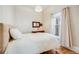 Bright bedroom with hardwood floors, a large window, and a bed with fresh white linens at 3106 N Franklin St, Denver, CO 80205