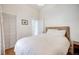 Neutral bedroom featuring a bed with white linens, wood floors, and a closet at 3106 N Franklin St, Denver, CO 80205