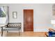 Foyer with hardwood floors, wooden door, bench, and soft, natural light at 3106 N Franklin St, Denver, CO 80205