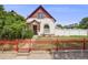 Charming home with a red fence, well-manicured lawn, and unique architectural details at 3106 N Franklin St, Denver, CO 80205
