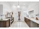 Traditional kitchen with white cabinets, stainless steel appliances, and bright natural light at 3106 N Franklin St, Denver, CO 80205