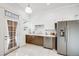 Updated kitchen with stainless steel appliances, tile floor, and white cabinets at 3106 N Franklin St, Denver, CO 80205