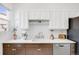 Well-lit kitchen featuring modern appliances, white countertops, and stylish backsplash at 3106 N Franklin St, Denver, CO 80205