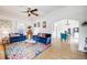 Open living room layout with hardwood floors flowing into dining area, and ceiling fan at 3106 N Franklin St, Denver, CO 80205