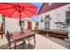 Outdoor patio featuring a dining area, grill, and a quaint white storage shed at 3106 N Franklin St, Denver, CO 80205