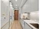 Hallway leading to modern kitchen features marble countertops and stainless steel appliances at 1901 Wazee St # 305, Denver, CO 80202