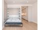 Open living space showing murphy bed pulled down, with a view into the modern kitchen at 1901 Wazee St # 305, Denver, CO 80202