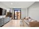 Bright living room features hardwood floors, a modern sofa, and a large window with an expansive city view at 1901 Wazee St # 305, Denver, CO 80202