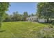 Large backyard with lush green grass and trees, offering ample space for outdoor activities at 366 Kenton St, Aurora, CO 80010