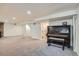 Spacious basement with carpet and a vintage piano against a stone wall at 366 Kenton St, Aurora, CO 80010