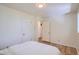 Bright bedroom featuring hardwood floors, white walls and trim, and an attached closet at 366 Kenton St, Aurora, CO 80010