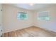 Spacious bedroom with hardwood floors and two windows offering natural light at 366 Kenton St, Aurora, CO 80010