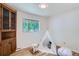 Charming bedroom with built-in wood cabinet, teepee, and a rocking sheep at 366 Kenton St, Aurora, CO 80010