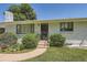 Close-up of the home's entrance, showing a well-maintained lawn and flower beds at 366 Kenton St, Aurora, CO 80010