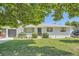 Charming brick home with a well-manicured lawn, established landscaping, and an attached garage at 366 Kenton St, Aurora, CO 80010