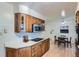 Well-lit kitchen featuring wood cabinetry, white countertops, and stainless steel appliances at 366 Kenton St, Aurora, CO 80010