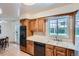 Well-appointed kitchen featuring stainless steel appliances and wood cabinetry at 366 Kenton St, Aurora, CO 80010