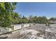 Open roof deck surrounded by trees offers a secluded outdoor space at 366 Kenton St, Aurora, CO 80010