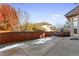 Private backyard with patio, wooden fence and some snow at 486 S Youngfield Cir, Lakewood, CO 80228
