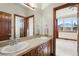 Bathroom boasts double sinks and a view from the adjacent bedroom at 486 S Youngfield Cir, Lakewood, CO 80228