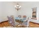 Formal dining room with hardwood floors and a glass-top dining table at 486 S Youngfield Cir, Lakewood, CO 80228