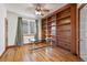 Spacious home office with hardwood floors and large bookcase at 486 S Youngfield Cir, Lakewood, CO 80228