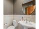 Powder room with pedestal sink and decorative tile at 486 S Youngfield Cir, Lakewood, CO 80228