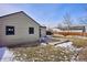 Side view of a spacious backyard with a wooden deck and partial fencing around the property at 1760 S Yuma St, Denver, CO 80223